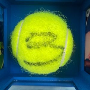 Coco Gauf autographed tennis ball with display cube